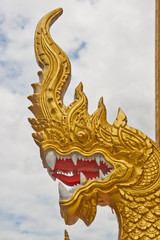 Large statue of golden snake / dragon creature