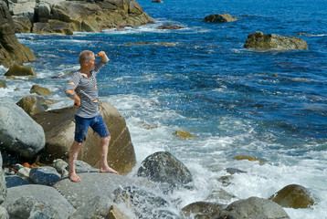 Man on stones at surf 3