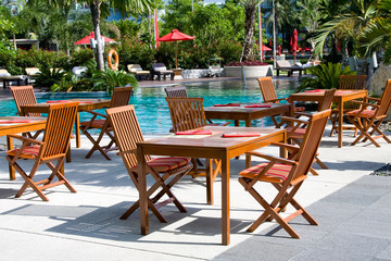 Table and chairs before pool