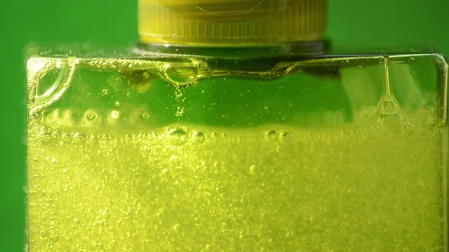 Green floating bubbles in a shampoo bottle