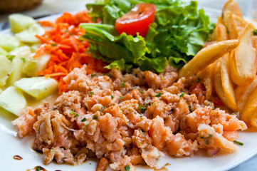 Fresh salmon salad with tomatoes.