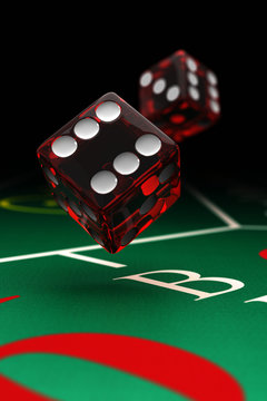 Two dice over craps table with selective focus