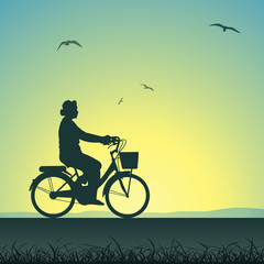 A Woman on a Bicycle in Silhouette
