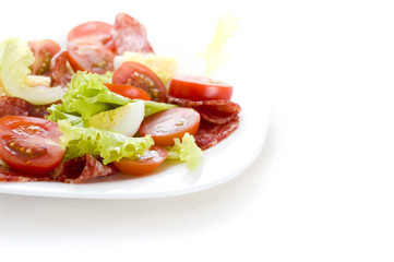 salad with salami, tomato