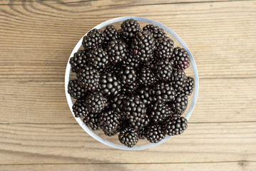 blackberries in bowl on desk
