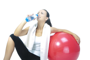 Fototapeta premium sportswoman with bottle of pure water sitting in front of red fi