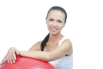 Obraz premium sensual smiling brunette with fitball after exercise isolated on