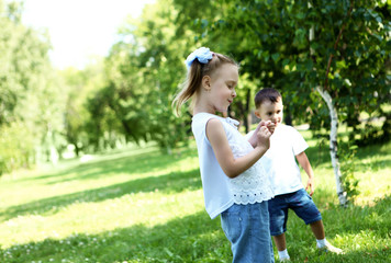 happy sister and brother outdoors