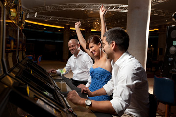 lucky female gambler and male friends celebrating