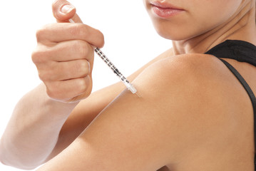 Woman making insulin fluvaccination  shot by syringe