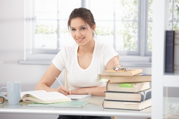 College student learning at home smiling