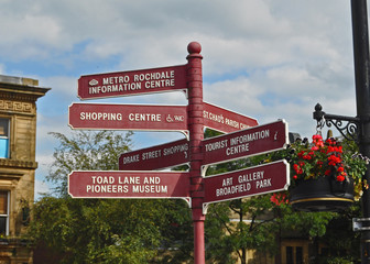 A signpost in the traditional industrial Northern mill town of Rochdale in Greater Manchester U.K. depicting various local points of interest