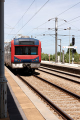 Passanger train stopped at empty portuguese station