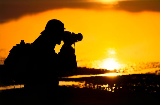 Photographer silhouette at sunset