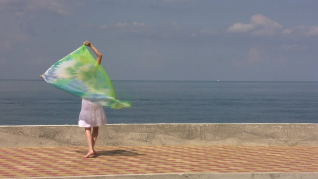 Young woman with pareu walk on seaside