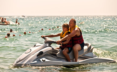 Father and son on a water bike .
