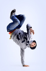 Young handsome fresh man breakdancing with