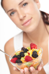 woman eating fruit salad