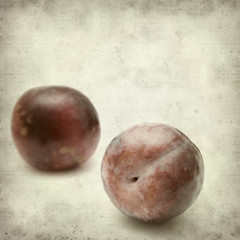 textured old paper background with large red plum fruit