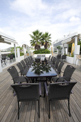 Beach cafe with  tables and chairs placed at the sea waterfront