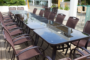 Beach cafe with  tables and chairs placed at the sea waterfront