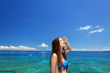 コマカ島の眩しい日差しを浴びる女性