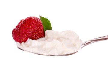 strawberry in spoon with cream isolated on white