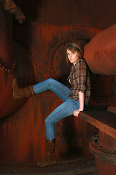 Young woman against old rusty metal