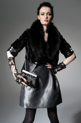 fashion model in autumn/winter clothes wearing sunglasses