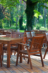 Obraz premium Wooden tables and chairs. Interior of the cafe.