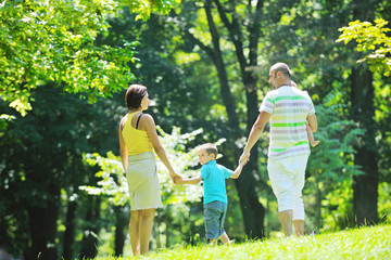 Fototapeta premium happy young couple with their children have fun at park