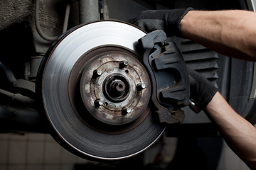 Fototapeta Car mechanic repair brake pads obraz