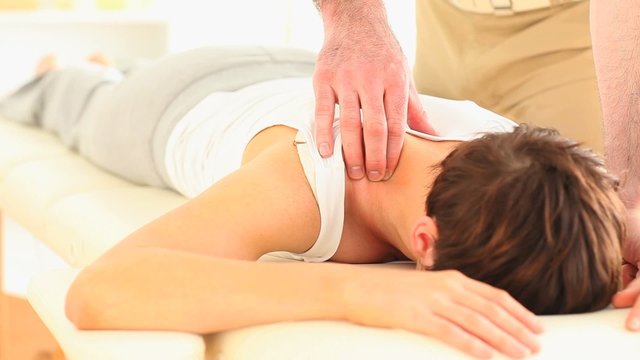 Man massaging a woman's neck