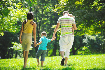 happy young couple with their children have fun at park