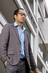 Business man portrait in front of office buildung