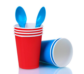 red plastic cups and blue spoons isolated on white