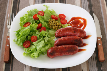 Fried sausages with salad