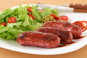 Fried sausages with salad