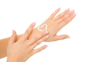 Poster Cream in a female hand on heart. © Sergey Khamidulin