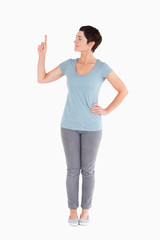Good looking woman pointing at copy space