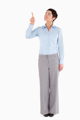 Businesswoman pointing at copy space © WavebreakmediaMicro