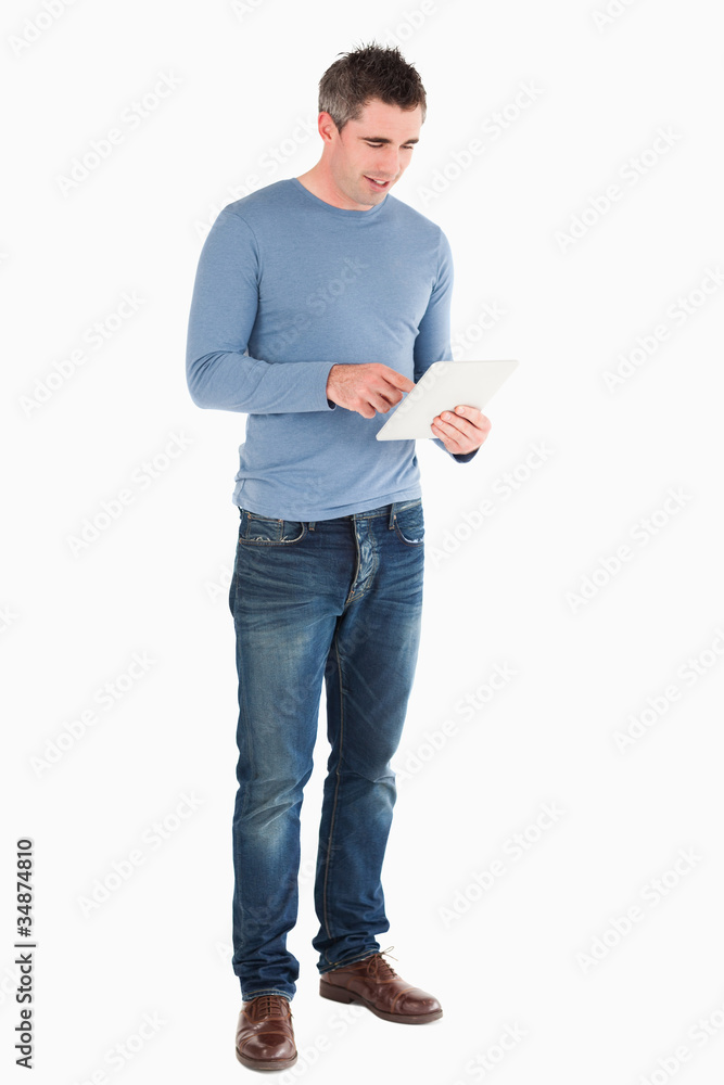 Poster Handsome man using a tablet computer