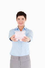 Woman showing a piggy bank