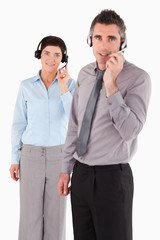 Portrait of coworkers using headsets