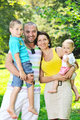 Fototapeta premium happy young couple with their children have fun at park