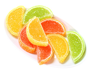 Fototapeta na wymiar Group of sweets as citrus fruits on white plate