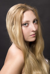Fototapeta premium Portrait of young beautiful girl with fair long hair