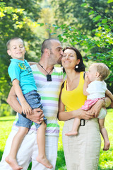 Fototapeta premium happy young couple with their children have fun at park