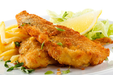 Fish dish - fried fish fillet, French fries with vegetables