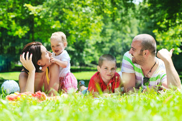 Fototapeta premium happy young couple with their children have fun at park
